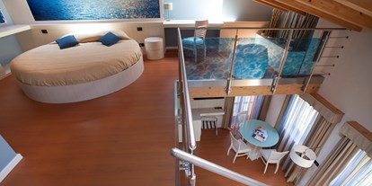 Hotels am See - Italien - Das Paradies existiert und in dieser Suite scheint man auf dem Wasser zu schweben, die Farbe Blau ist hier dominierend.
Penthouse von 45 m² mit großem Wohnzimmer, Schlafzimmer im Dach, 2 Badezimmer (eine von 6/7 m² mit Badewanne mt Dusche und eine von 4/5 m² mit Hydro-Dusche), 1 schönem Balkon (5/6 m²) und 2 Fenster, alle mit Seeblick. - Belfiore Park Hotel
